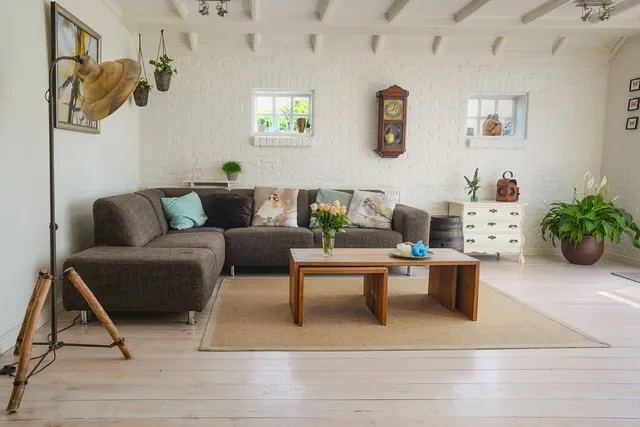 A natural-fibre area rug under a wooden coffee table in a bright living room.