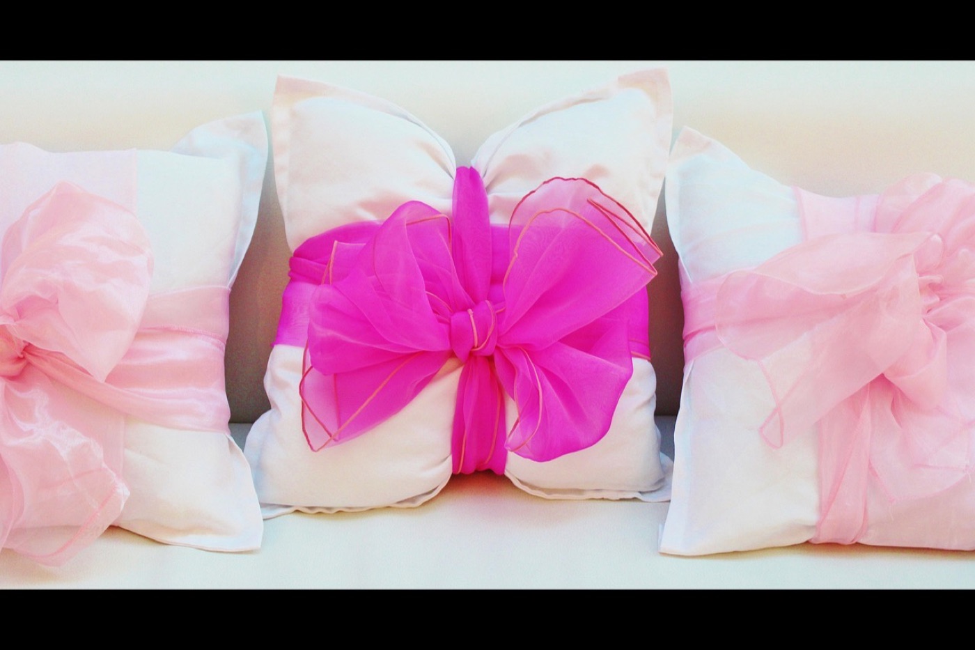 An 18 inch cushion cover laid flat next to a 20 inch pillow insert, showing the two inch size difference.